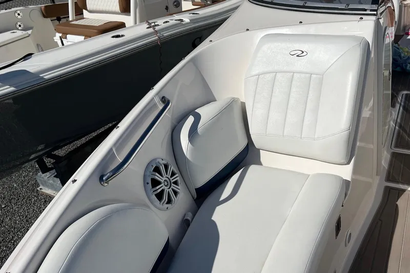 Slide: The Image of 2005 Regal 2400 Bowrider boat interior with white cushioned seating and speaker. - 27