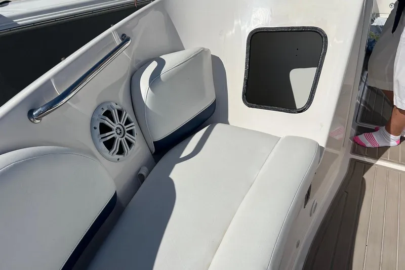 Slide: The Image of 2005 Regal 2400 Bowrider interior with white seating and speaker detail. - 28