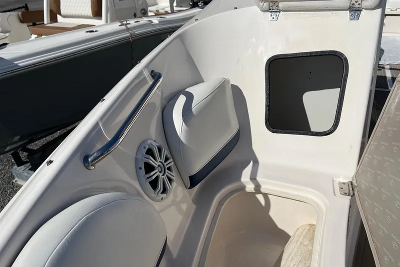 Slide: The Image of 2005 Regal 2400 Bowrider interior with seating, speaker, and storage compartment. - 29