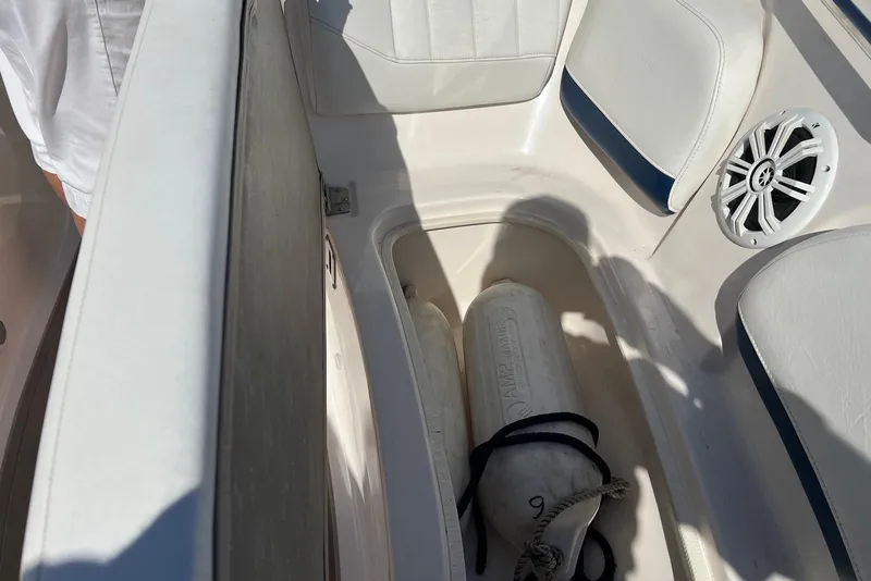 Slide: The Image of 2005 Regal 2400 Bowrider interior with storage compartment and marine speaker. - 30
