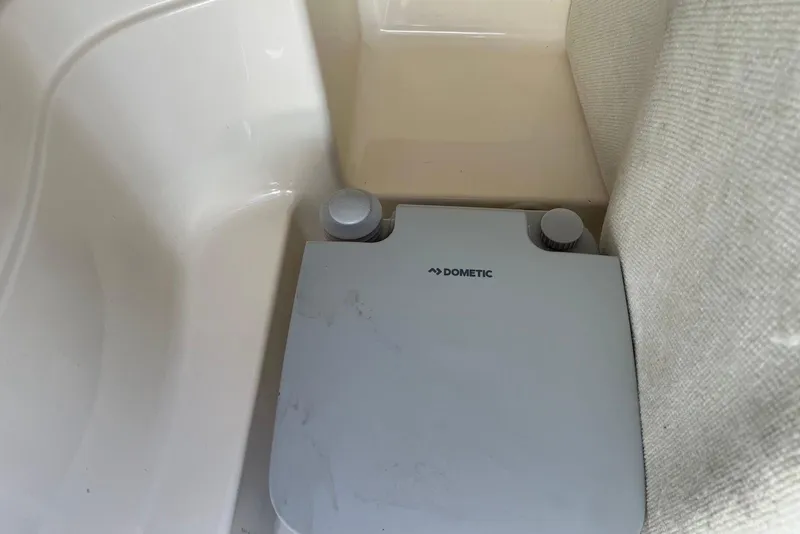 Slide: The Image of Dometic portable toilet in 2005 Regal 2400 Bowrider boat interior. - 38