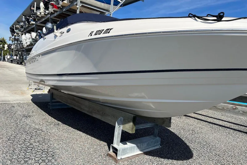 Slide: The Image of 2005 Regal 2400 Bowrider boat on dry dock under clear blue sky. - 4