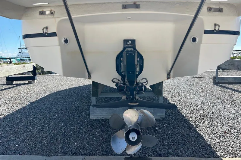 Slide: The Image of Rear view of a 2005 Regal 2400 Bowrider boat with Mercury outdrive. - 7
