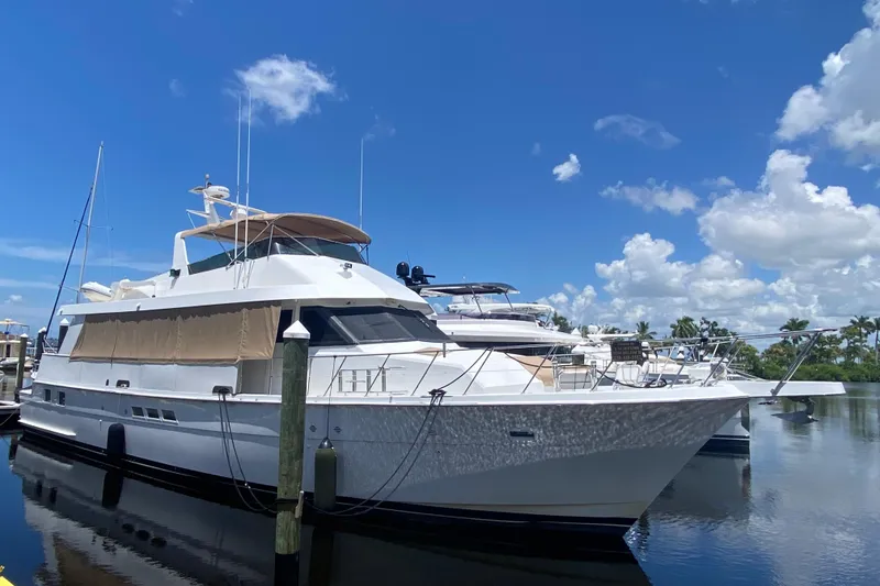 The Image of 1991 Hatteras 70 Cockpit Motor Yacht docked under a clear blue sky. - 0