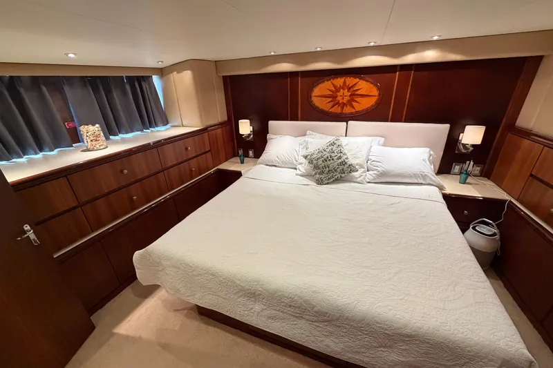 Slide: The Image of Luxurious bedroom interior of 1991 Hatteras 70 Motor Yacht with elegant wood finishes. - 102