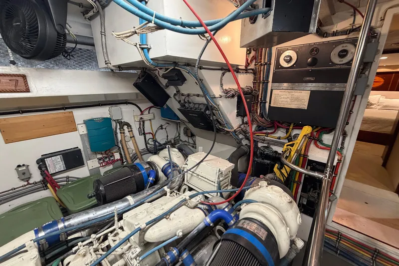 Slide: The Image of Engine room of a 1991 Hatteras 70 Motor Yacht with wiring and machinery. - 115