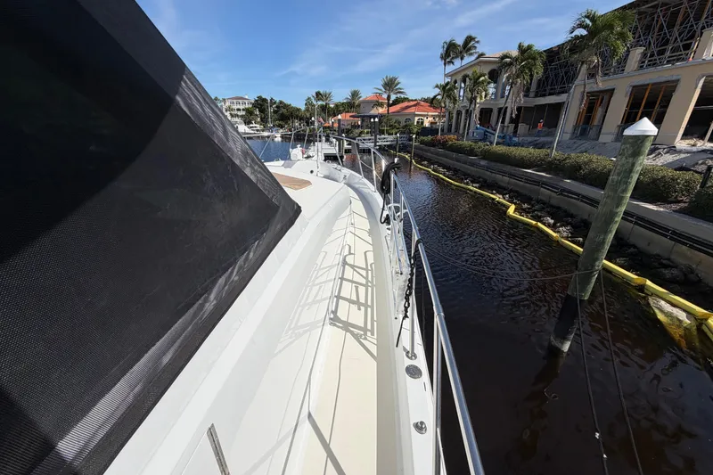 Slide: The Image of Bow view of 1991 Hatteras 70 Motor Yacht docked in marina. - 17