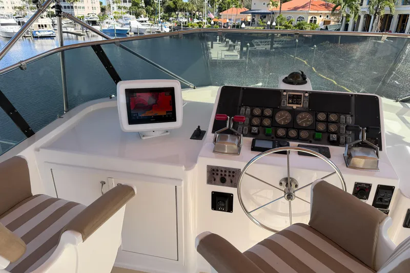 Slide: The Image of 1991 Hatteras 70 Motor Yacht helm with controls and navigation instruments. - 44
