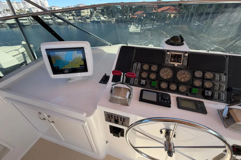 Slide: The Image of Cockpit of 1991 Hatteras 70 Motor Yacht with navigation equipment and striped seating. - 46
