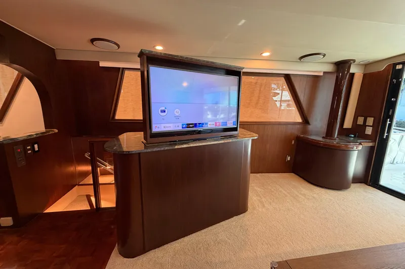 Slide: The Image of Luxurious interior of 1991 Hatteras 70 Motor Yacht with modern kitchen and cozy seating area. - 57