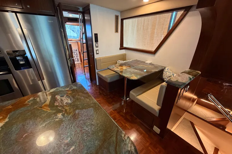 Slide: The Image of Interior of 1991 Hatteras 70 Motor Yacht with elegant dining area and wood accents. - 60