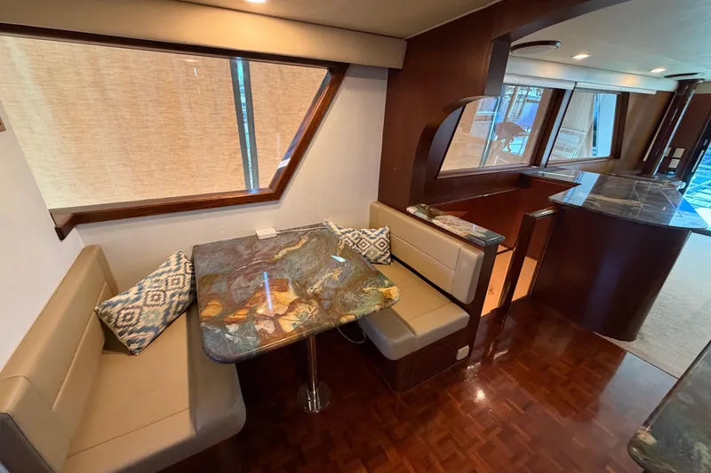 Slide: The Image of Luxurious 1991 Hatteras 70 Motor Yacht interior with modern kitchen and dining area. - 61