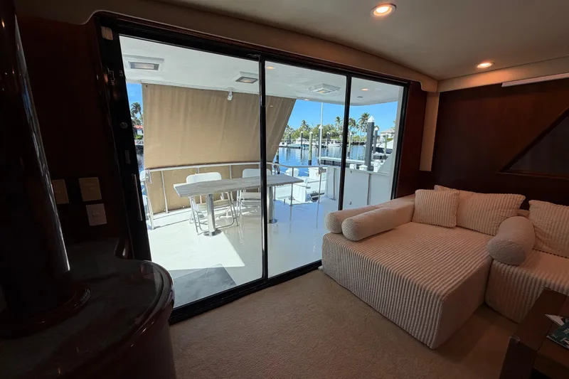 Slide: The Image of Interior of 1991 Hatteras 70 Motor Yacht with elegant dining area and wood finishes. - 62