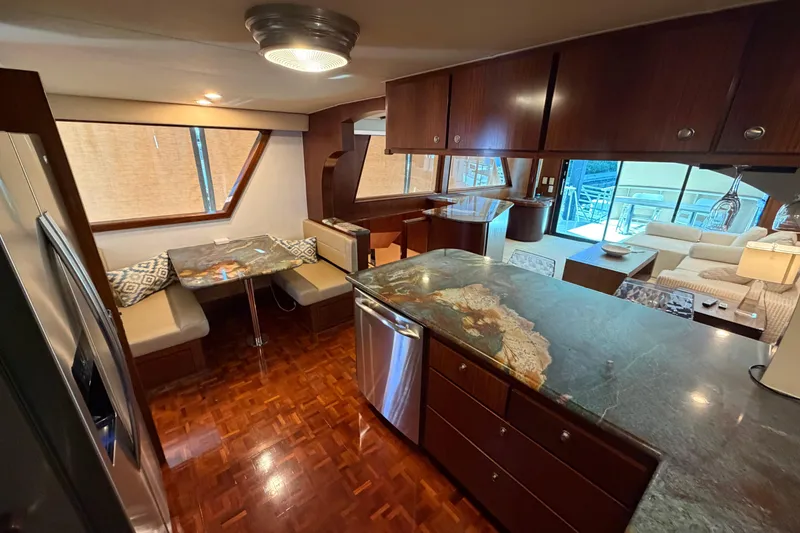 Slide: The Image of Interior view of 1991 Hatteras 70 Motor Yacht with cozy seating and outdoor deck. - 63
