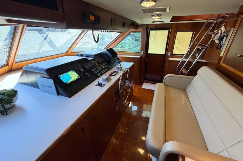 Slide: The Image of 1991 Hatteras 70 Motor Yacht helm with navigation equipment and panoramic windows. - 70