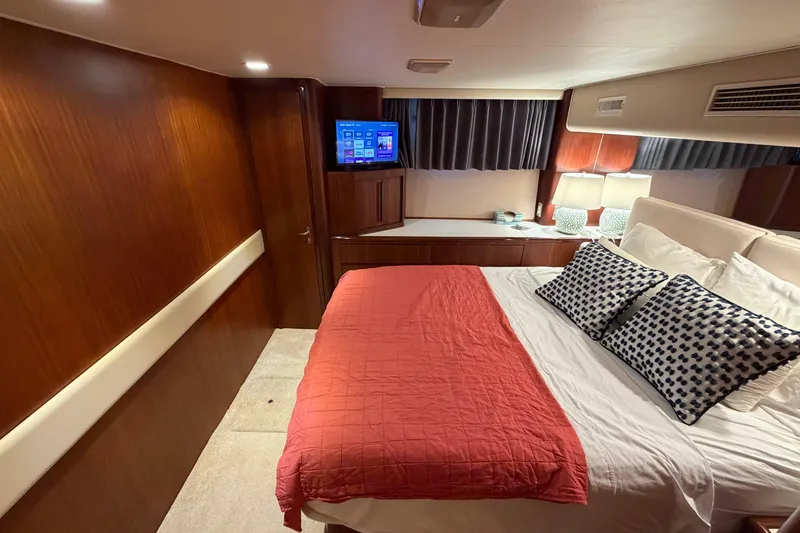Slide: The Image of Staircase inside 1991 Hatteras 70 Motor Yacht with wooden paneling and carpeted steps. - 76