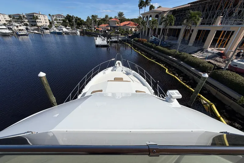 Slide: The Image of 1991 Hatteras 70 Motor Yacht docked under clear blue sky. - 8