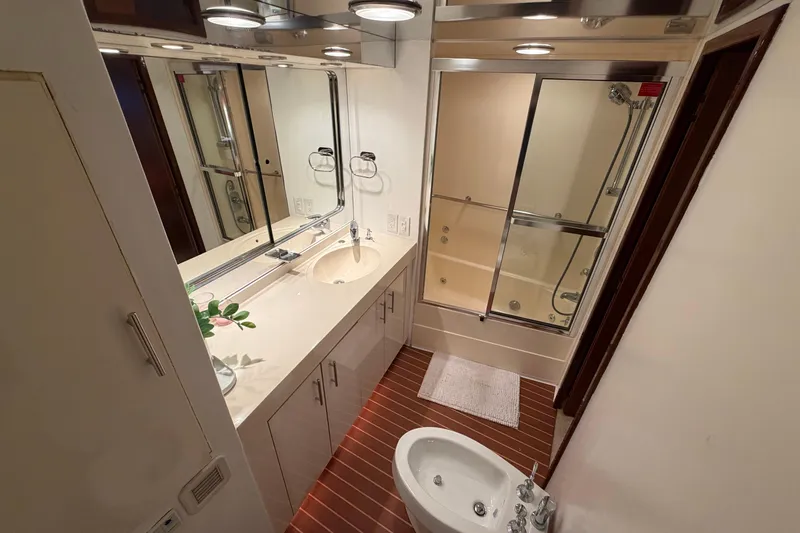 Slide: The Image of Luxurious bathroom in a 1991 Hatteras 70 Motor Yacht with modern fixtures and elegant design. - 81