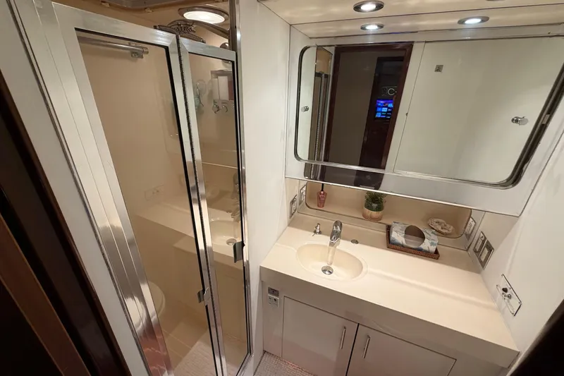 Slide: The Image of Bathroom interior of 1991 Hatteras 70 Motor Yacht with sink, mirror, and toilet. - 87