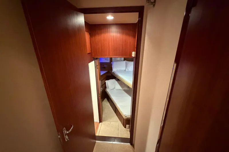 Slide: The Image of Shower area in 1991 Hatteras 70 Motor Yacht with modern fixtures and storage. - 89