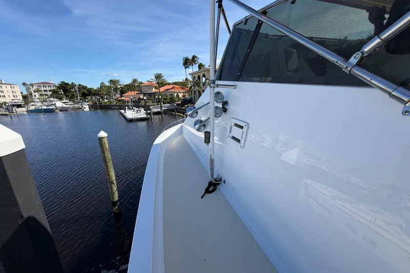 Slide: The Image of Bow view of 1991 Hatteras 70 Motor Yacht docked in a marina. - 9