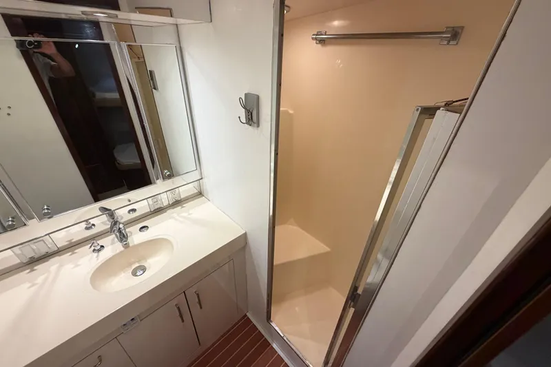 Slide: The Image of Cozy cabin interior of 1991 Hatteras 70 Motor Yacht with bed and porthole. - 92