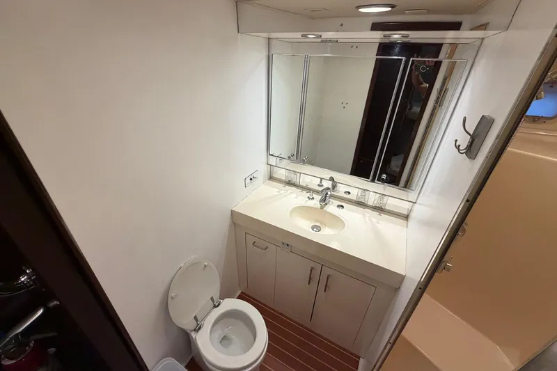 Slide: The Image of Bathroom interior of 1991 Hatteras 70 Motor Yacht with sink, mirror, and shower. - 94