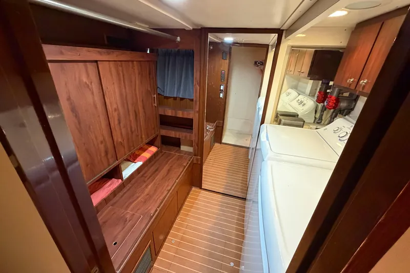 Slide: The Image of Staircase inside 1991 Hatteras 70 Motor Yacht with wooden steps and handrail. - 97