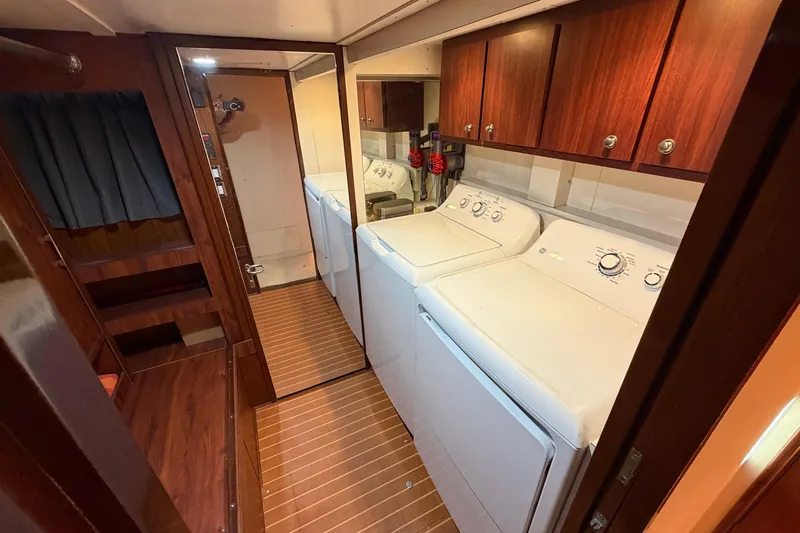 Slide: The Image of Interior of 1991 Hatteras 70 Motor Yacht with wood paneling and laundry area. - 98