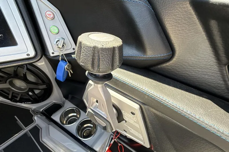 Slide: The Image of 2023 Supra SE 550 interior with control panel and key ignition. - 16