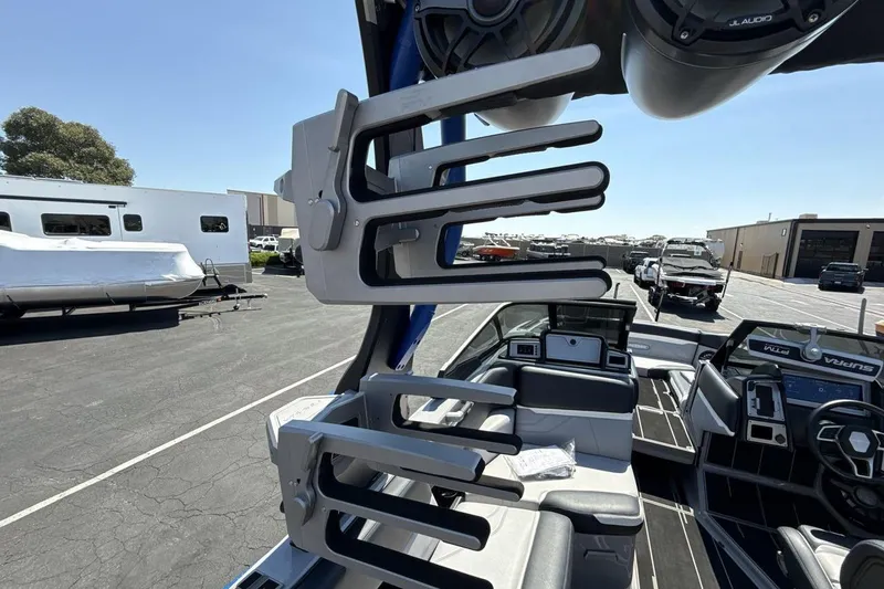 Slide: The Image of 2023 Supra SE 550 boat interior with wakeboard racks and advanced audio system. - 22