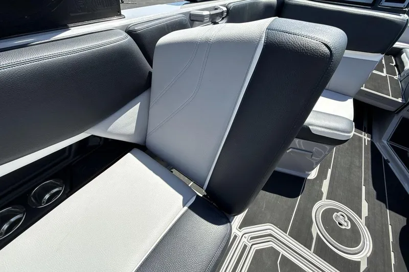 Slide: The Image of 2023 Supra SE 550 boat interior with sleek black and white seating design. - 24