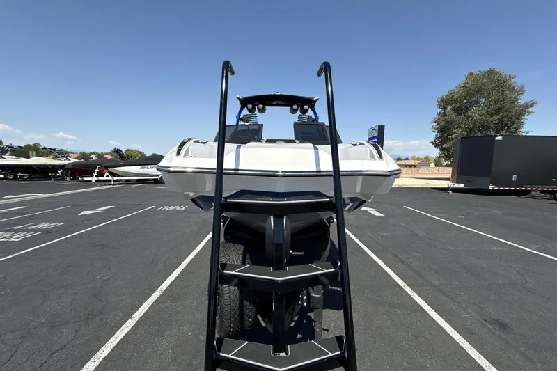 Slide: The Image of 2023 Supra SE 550 boat on trailer in parking lot, front view. - 8