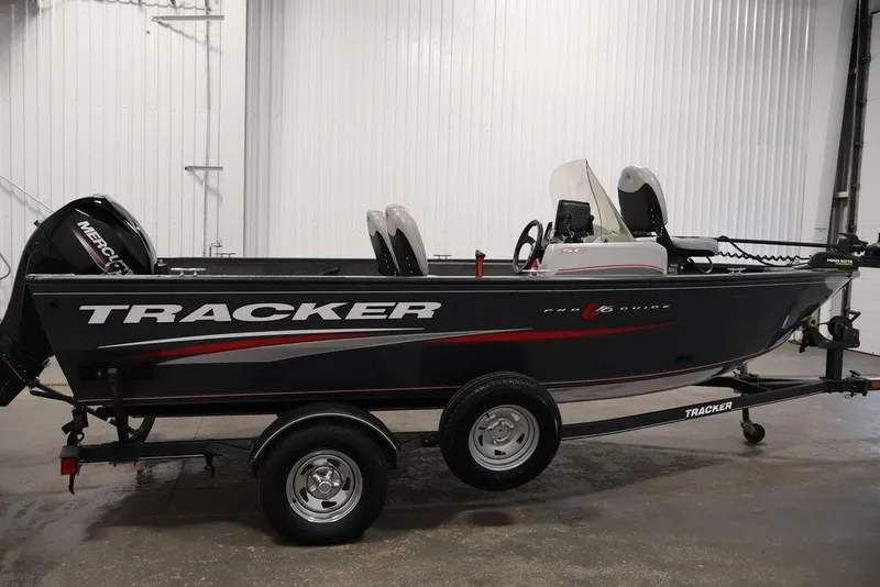 Slide: The Image of 2019 Tracker Pro Guide V-16 SC fishing boat on trailer in indoor setting. - 10