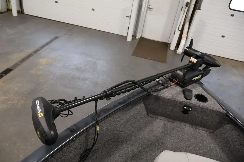 Slide: The Image of 2019 Tracker Pro Guide V-16 SC boat with Minn Kota trolling motor in a garage. - 11