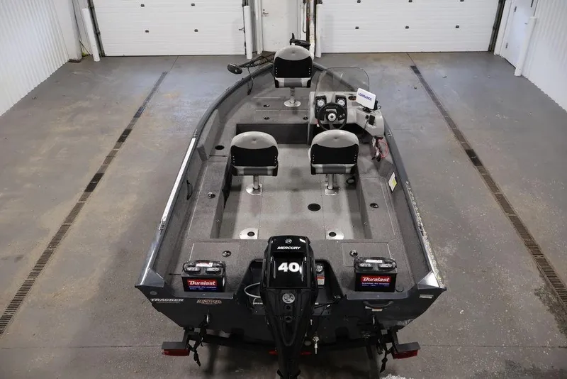Slide: The Image of 2019 Tracker Pro Guide V-16 SC fishing boat in a garage setting. - 14