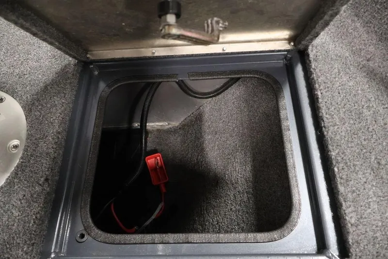 Slide: The Image of 2019 Tracker Pro Guide V-16 SC boat storage compartment with wiring and red connector. - 17