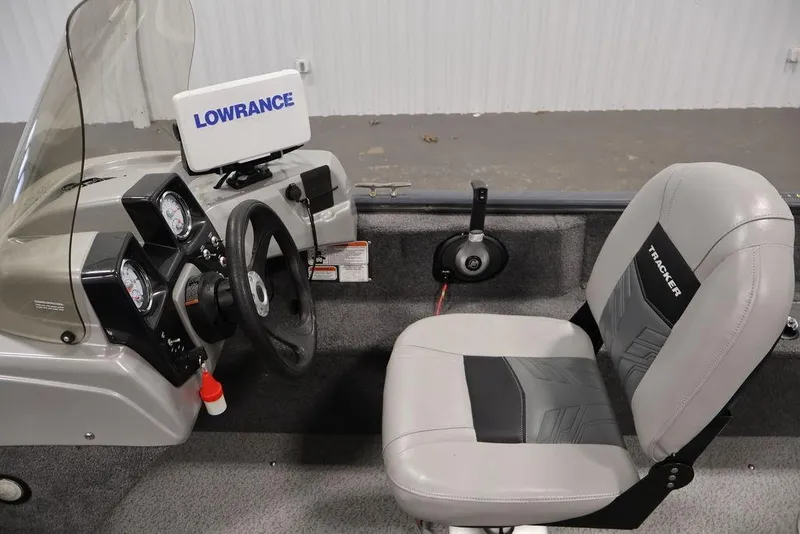 Slide: The Image of 2019 Tracker Pro Guide V-16 SC boat interior with steering wheel and Lowrance device. - 22