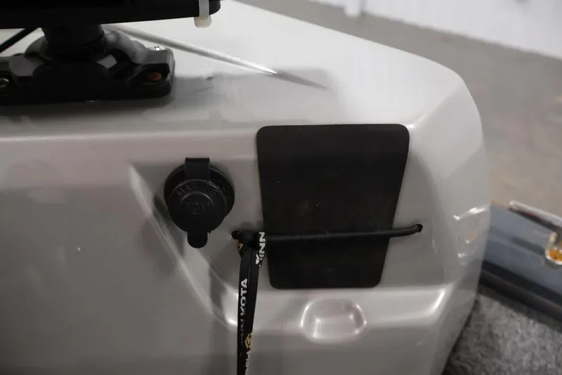 Slide: The Image of 2019 Tracker Pro Guide V-16 SC boat detail with power outlet and accessory holder. - 24