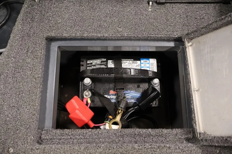 Slide: The Image of 2019 Tracker Pro Guide V-16 SC marine battery compartment with maintenance-free battery. - 32