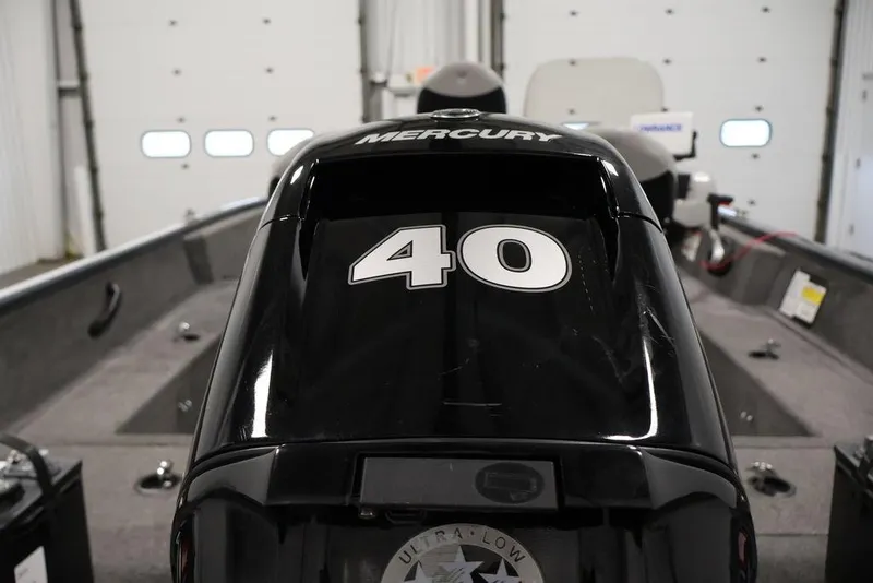 Slide: The Image of 2019 Tracker Pro Guide V-16 SC boat with Mercury 40 HP engine in a garage. - 35