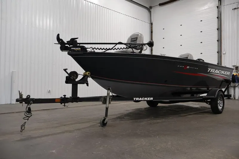 Slide: The Image of 2019 Tracker Pro Guide V-16 SC boat on trailer in a garage setting. - 37