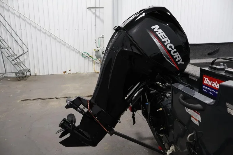 Slide: The Image of 2019 Tracker Pro Guide V-16 SC with Mercury outboard motor in a garage setting. - 38