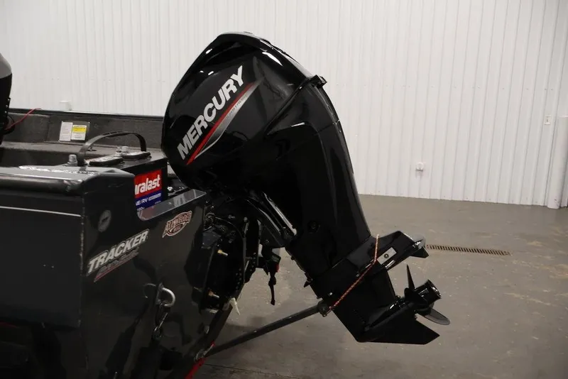 Slide: The Image of 2019 Tracker Pro Guide V-16 SC boat with Mercury outboard motor in a garage. - 39