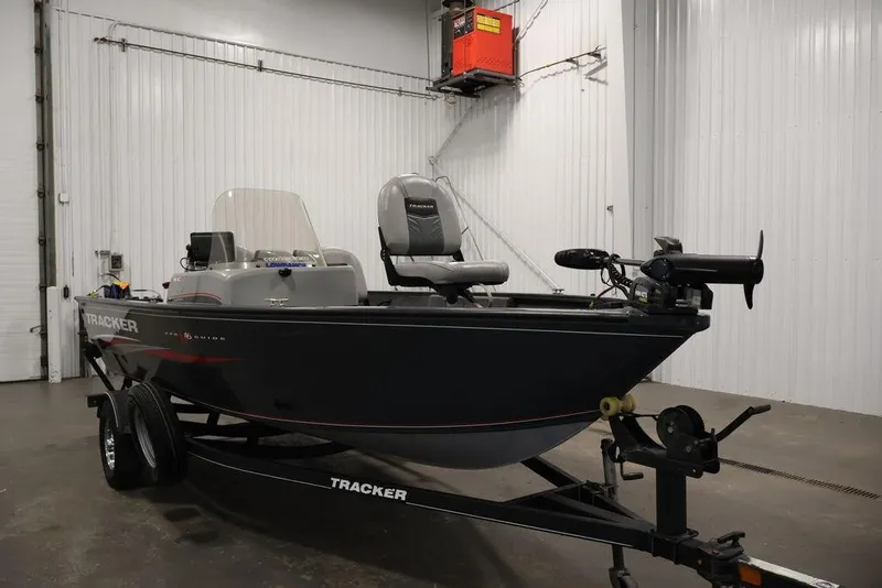 Slide: The Image of 2019 Tracker Pro Guide V-16 SC fishing boat on trailer in indoor storage. - 4