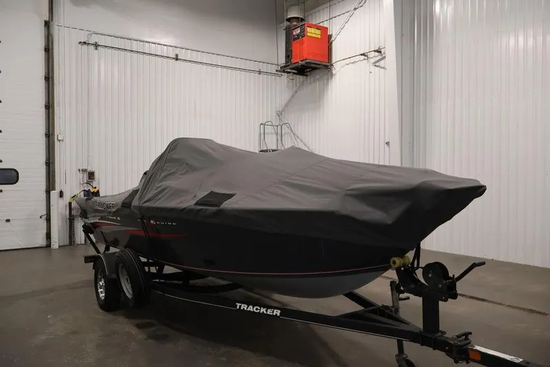 Slide: The Image of 2019 Tracker Pro Guide V-16 SC boat covered in a garage setting. - 40