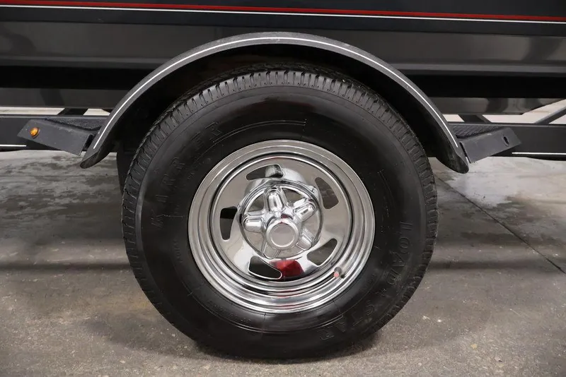 Slide: The Image of 2019 Tracker Pro Guide V-16 SC trailer wheel with chrome rim and black tire. - 41