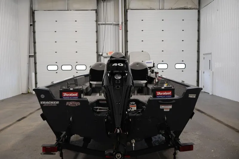 Slide: The Image of 2019 Tracker Pro Guide V-16 SC boat in a garage, rear view. - 5