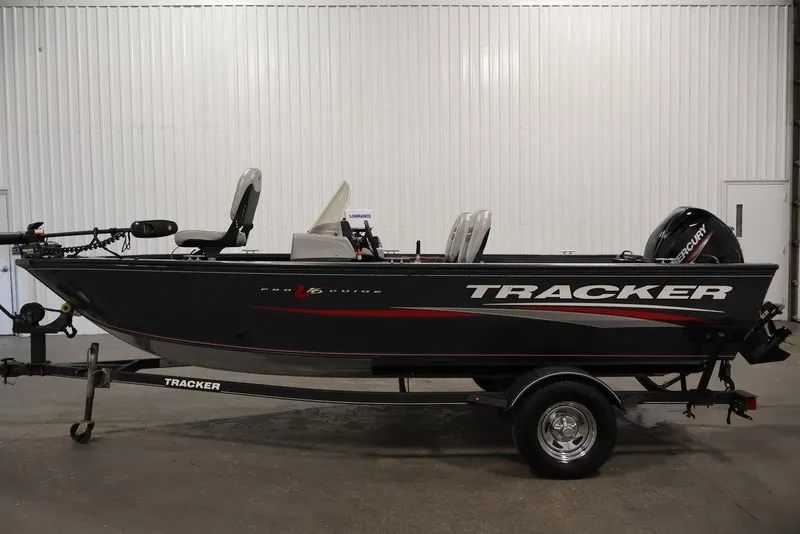 Slide: The Image of 2019 Tracker Pro Guide V-16 SC fishing boat on trailer in indoor setting. - 6