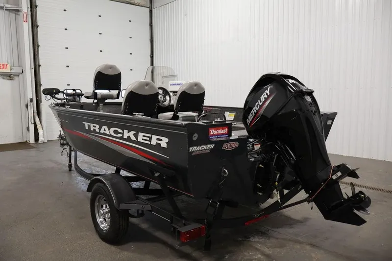 Slide: The Image of 2019 Tracker Pro Guide V-16 SC boat with Mercury engine in a garage. - 7